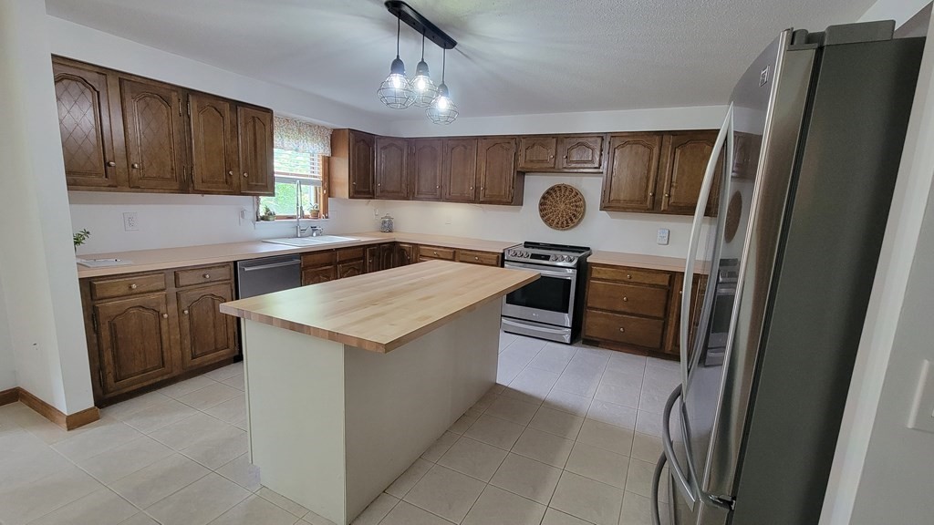 9 David Drive Pelham, NH 03076 - Photo 5 of 42 a kitchen with a stove and a refrigerator