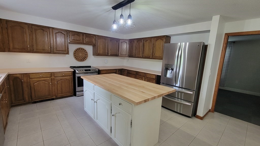 9 David Drive Pelham, NH 03076 - Photo 6 of 42 a kitchen with stainless steel appliances granite countertop a sink a refrigerator and a stove