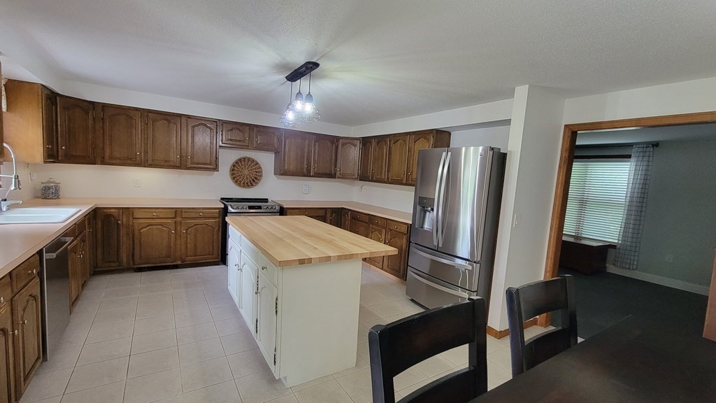 9 David Drive Pelham, NH 03076 - Photo 8 of 42 a kitchen with a sink appliances and cabinets