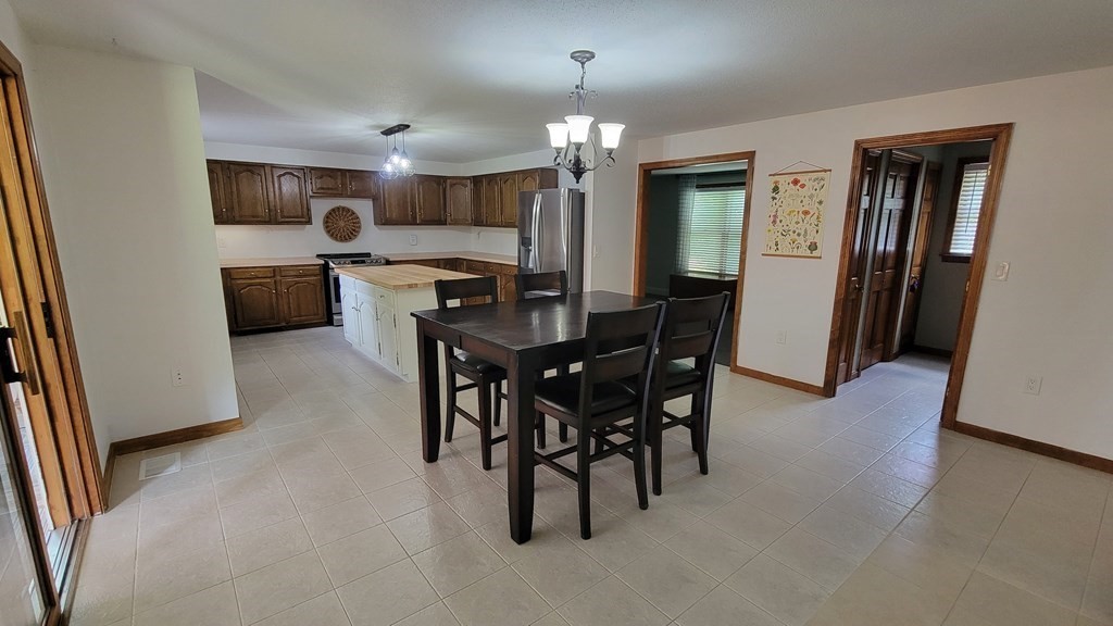 9 David Drive Pelham, NH 03076 - Photo 10 of 42 a view of a dining room with furniture and wooden floor
