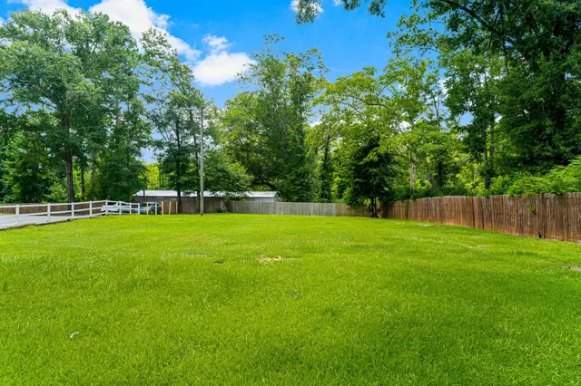 a view of a park with trees in the background
