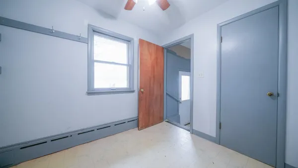 a view of empty room with wooden walls