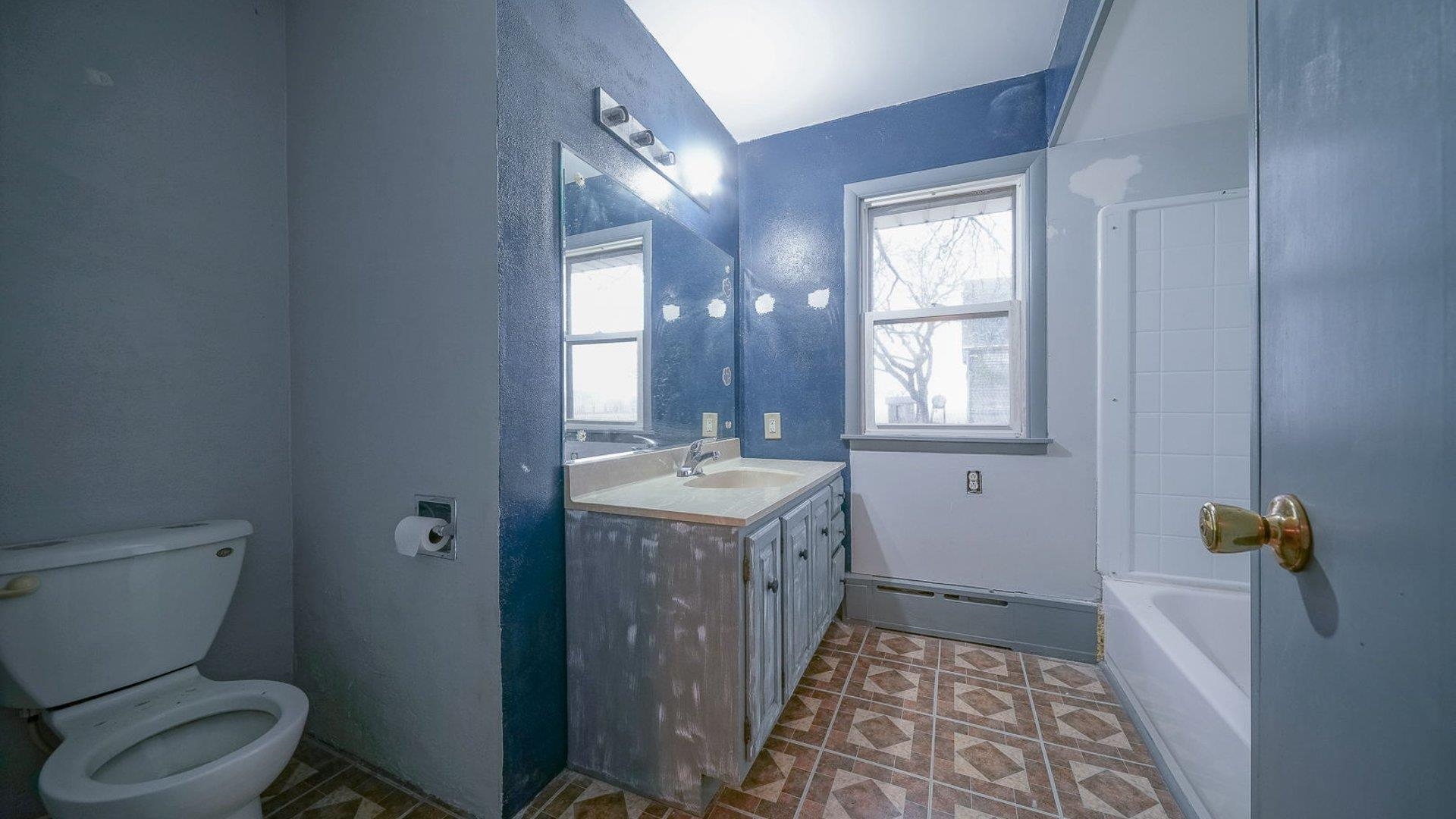 2610 Klinger Road Pecatonica, IL 61063 - Photo 22 of 53 a bathroom with a granite countertop toilet a sink and mirror