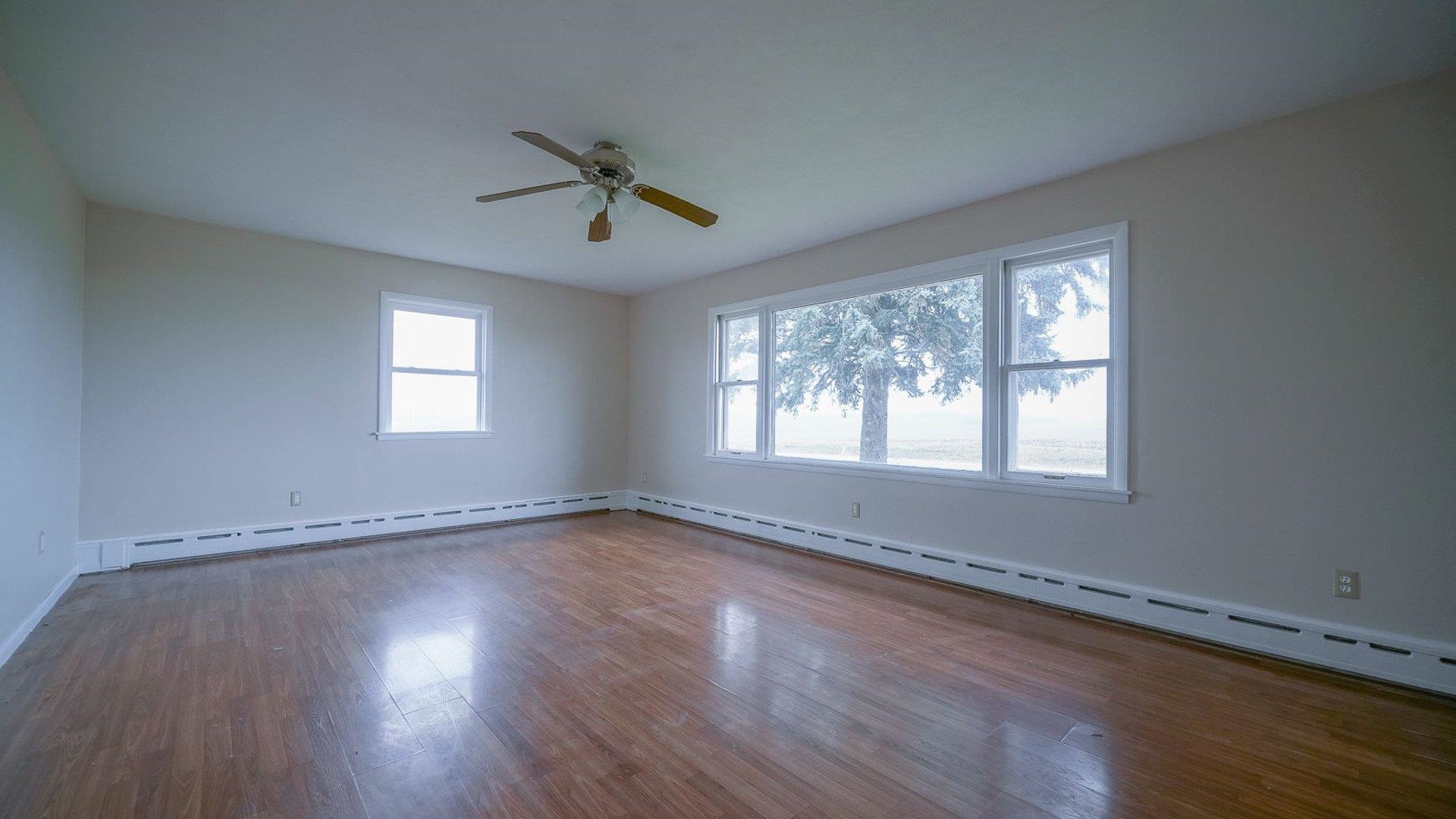 2610 Klinger Road Pecatonica, IL 61063 - Photo 28 of 53 a view of an empty room with wooden floor and a window