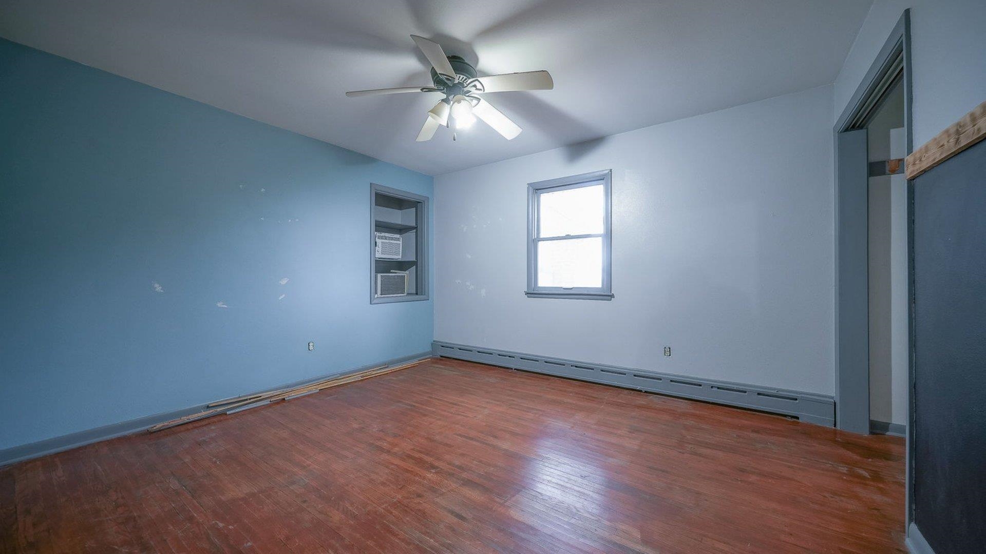 2610 Klinger Road Pecatonica, IL 61063 - Photo 36 of 53 an empty room with wooden floor and windows