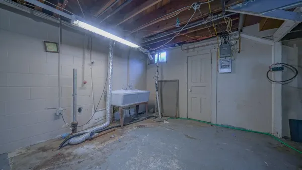 a view of a livingroom with wooden floor and a window