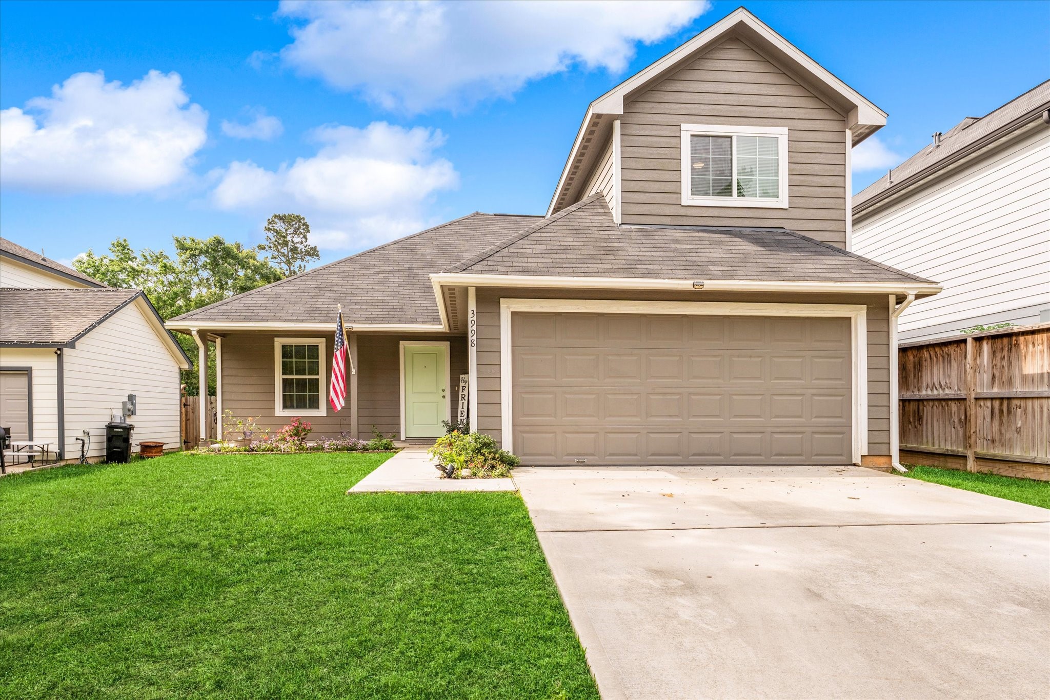 3998 Frontier Road Willis, TX 77378 - Photo 2 of 33 a front view of a house with a yard and garage