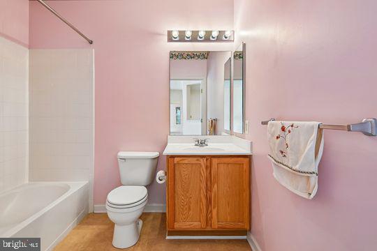 9511 Kingscroft Terrace, Unit 9511F Perry Hall, MD 21128 - Photo 38 of 38 a bathroom with a toilet sink and mirror