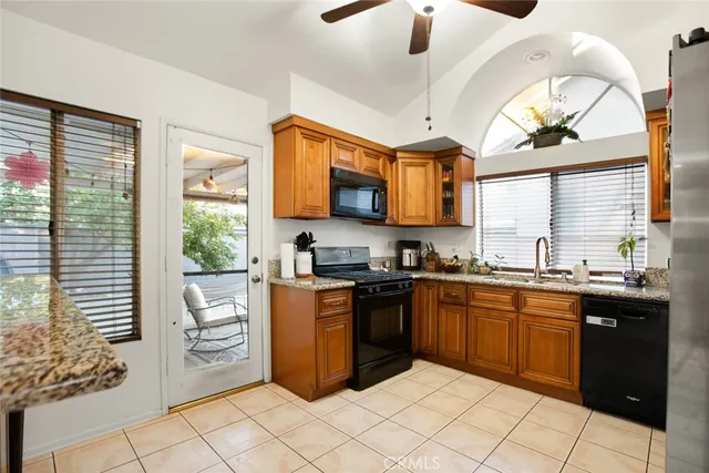 a kitchen with stainless steel appliances kitchen island granite countertop a sink and cabinets