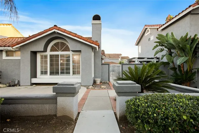 a front view of a house with a garden