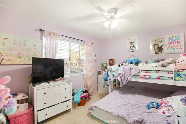 a bedroom with furniture and a flat screen tv