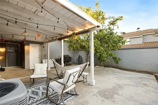 a view of a patio with table and chairs and potted plants