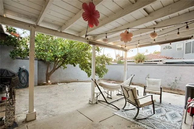a view of a patio with table and chairs and potted plants