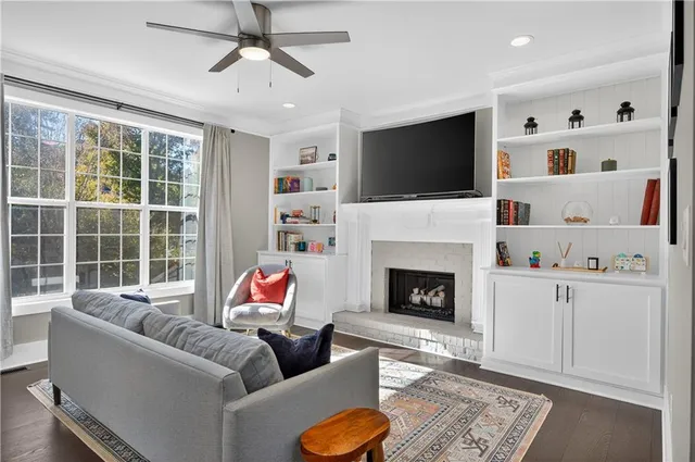 a living room with furniture fireplace and flat screen tv