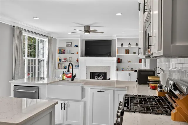 a kitchen with a stove a sink and a microwave