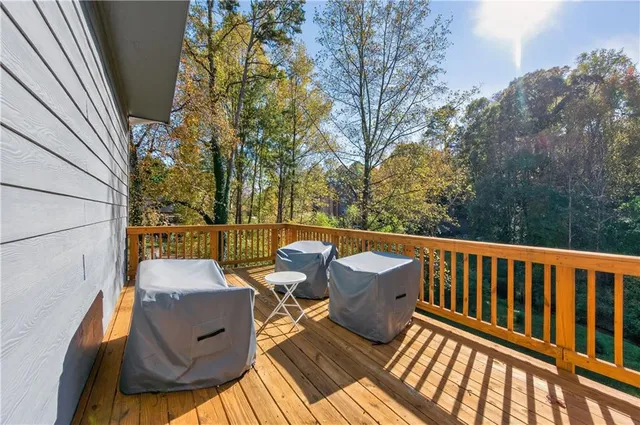 a view of balcony with wooden floor and outdoor seating