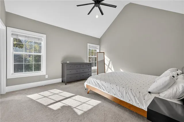 a bedroom with a bed dresser and a window