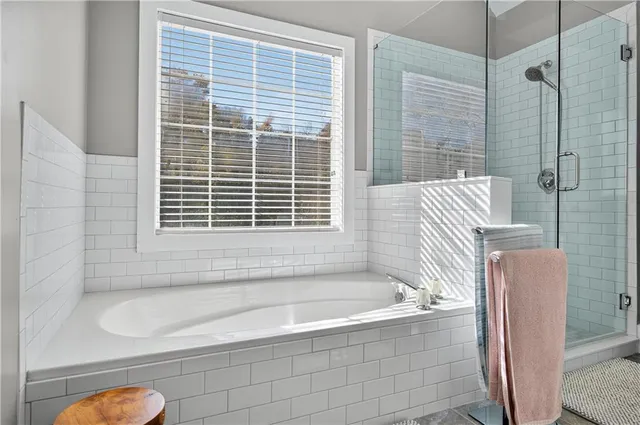 a bathroom with a bathtub and a shower