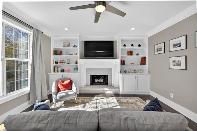 a living room with furniture a flat screen tv and a fireplace
