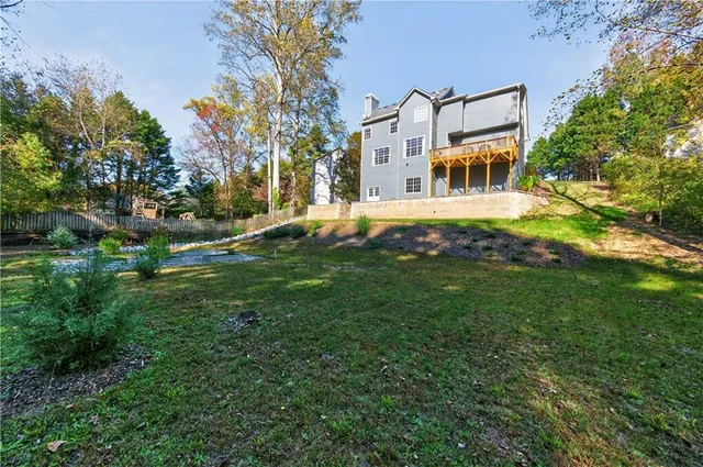 a backyard of a house with table and chairs