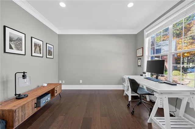 a view of a workspace with furniture and a window