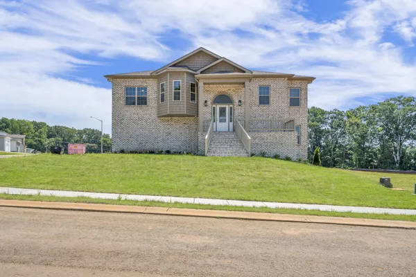 a front view of a house with a yard