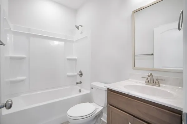 a bathroom with a sink a toilet and a bathtub