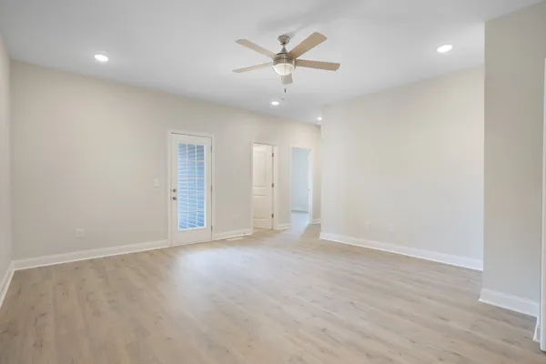 a view of an empty room with a ceiling fan