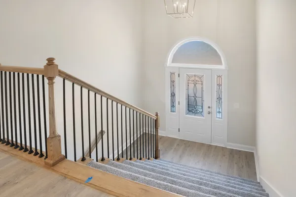 a view of a hallway with entryway wooden floor and front door