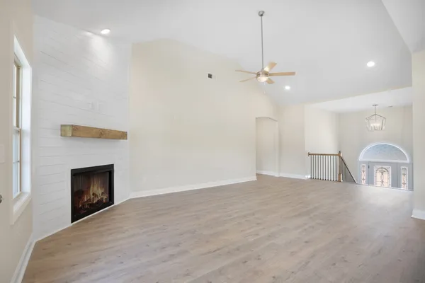 a view of livingroom with chandelier fan and fire place