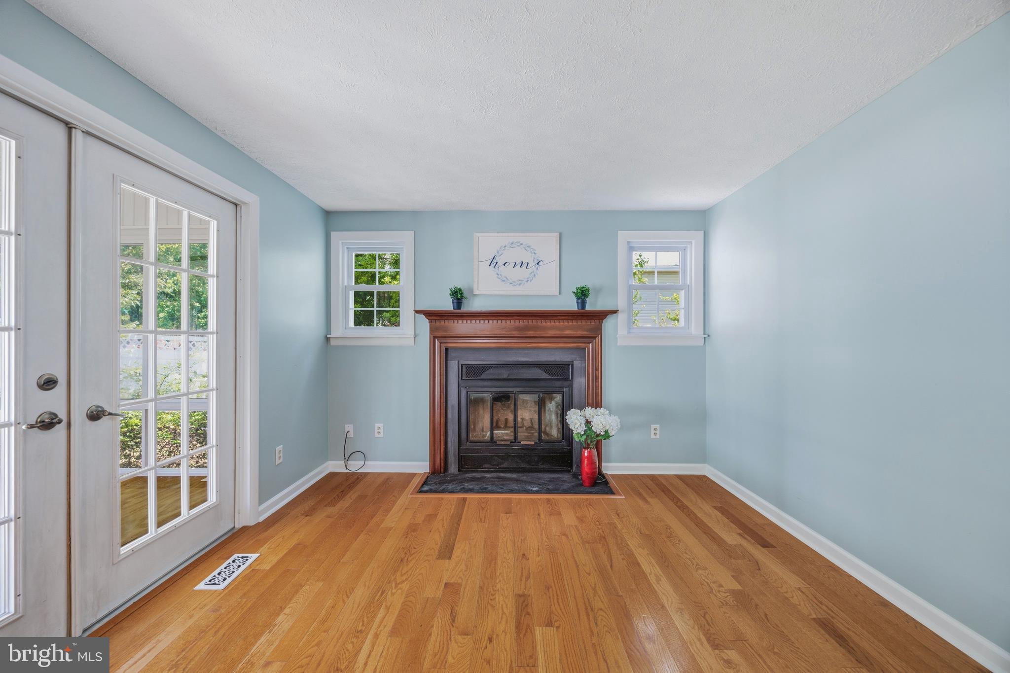 1506 Gollum Road Hanover, MD 21076 - Photo 16 of 44 a view of an empty room with wooden floor fireplace and a window
