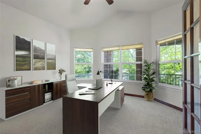 a room with a large window and furniture