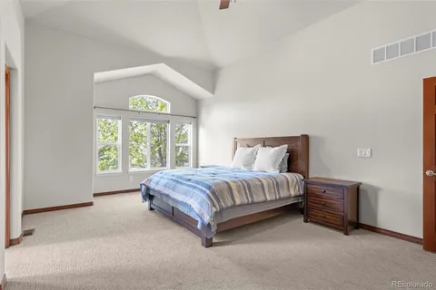 a spacious bedroom with a bed and a window