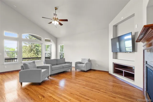 a living room with furniture wooden floor and a fireplace