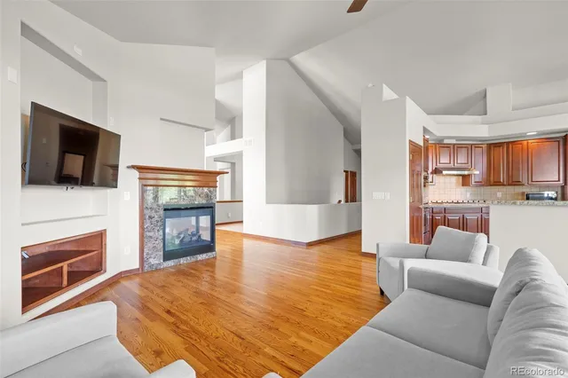 a living room with fireplace furniture and a flat screen tv
