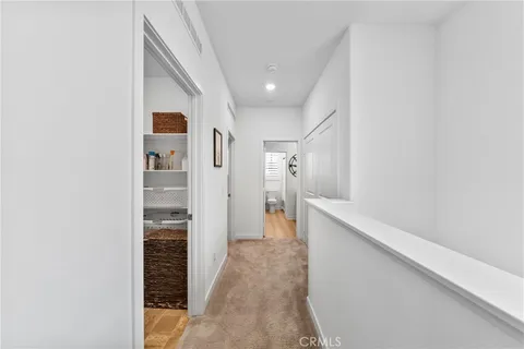 a view of hallway with wooden floor