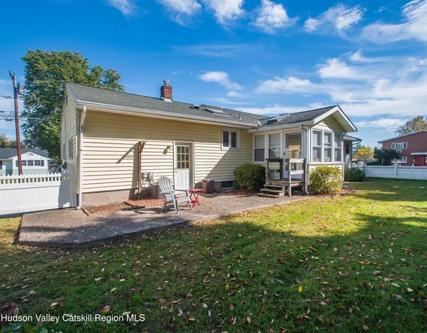 a front view of house with yard and outdoor seating