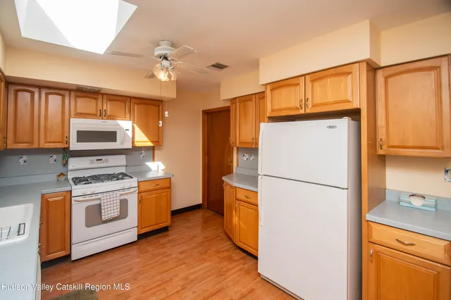 a kitchen with a refrigerator a stove top oven a sink and dishwasher