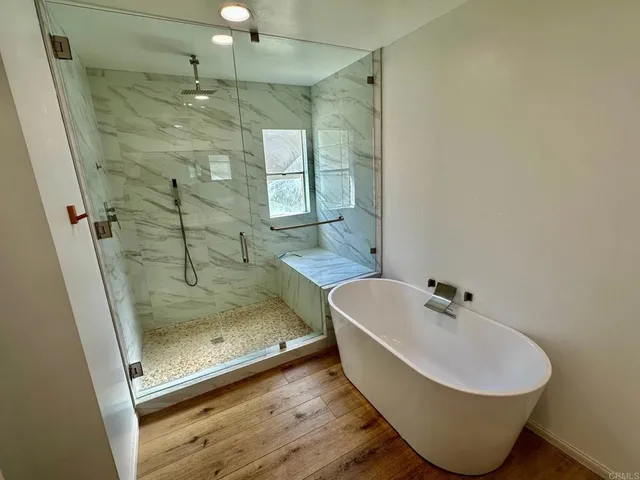 a bathroom with a bathtub and shower