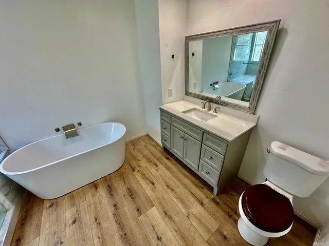 a bathroom with a sink mirror vanity and toilet