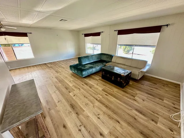 a living room with a bed furniture and a window