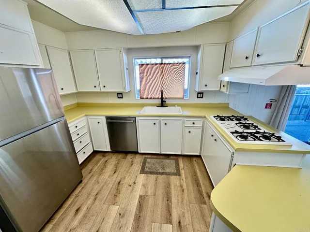 a kitchen with a sink a stove and refrigerator