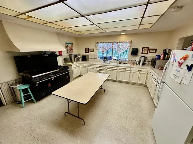 a kitchen with stainless steel appliances kitchen island granite countertop a sink and cabinets
