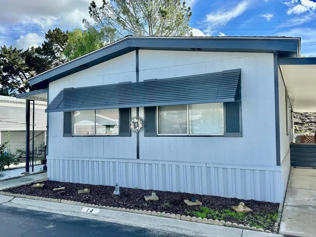 a view of a house with a small yard