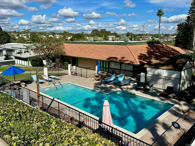 a view of a swimming pool and outdoor seating