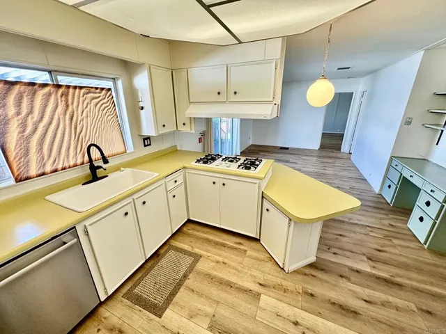 a kitchen with a sink appliances and cabinets