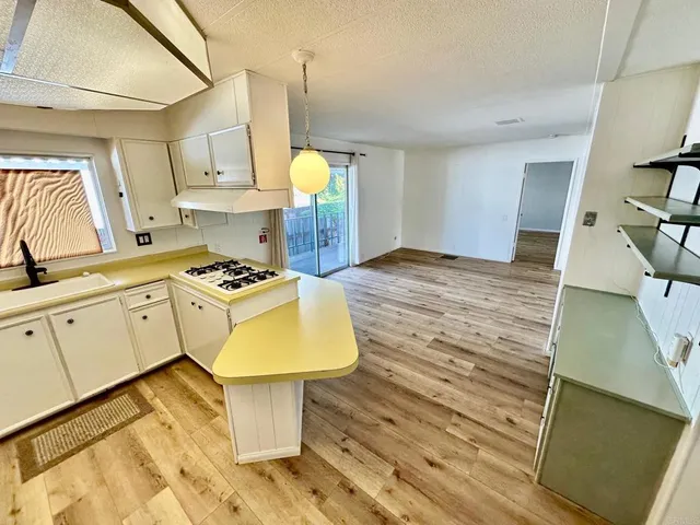 a kitchen with a sink appliances and cabinets