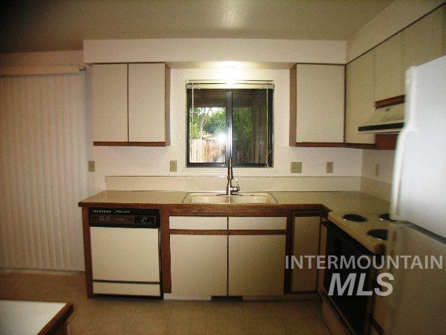 1484 East Carter Lane Boise, ID 83706 - Photo 2 of 9 Kitchen featuring dishwasher, freestanding refrigerator, black electric range oven, light countertops, and extractor fan
