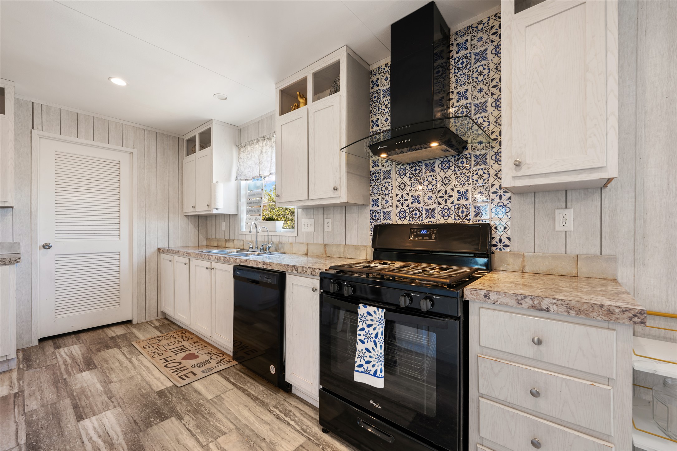 113 Sunflower Road Dale, TX 78616 - Photo 10 of 33 A classic gas range and patterned tile backsplash anchor this updated workspace.