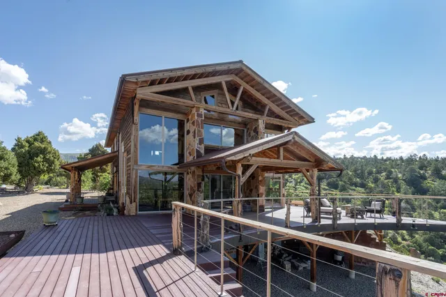 a view of deck with furniture and umbrella